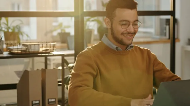 Business owner reviewing cybersecurity on laptop