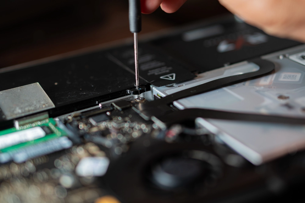 laptop being repaired by a digital den technician