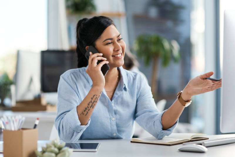 Shot Of A Young Businesswoman Talking On A Cellphone While Worki